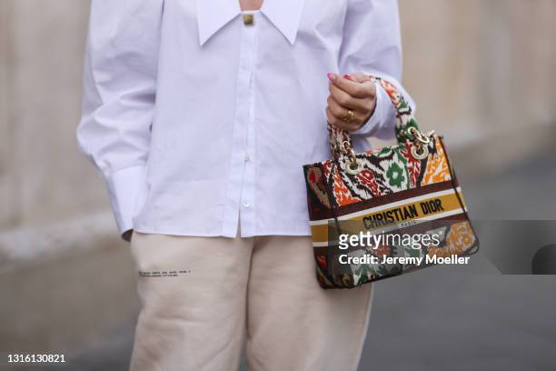 Sonia Lyson wearing white Uterque blouse, beige The Pangaia sweatpants and Lady Dior bag on April 26, 2021 in Berlin, Germany.