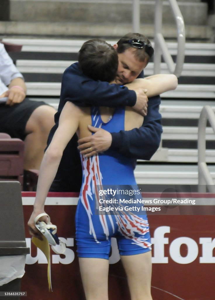 Joey, foreground, hugs father Joe at the edge of the stands.Oley Valley's Joey Fick pins Palmerton's Sam Oberlander in 2:06 to place seventh at 120 pounds.WRESTLING PIAA-AA individual championships at the Giant Center, Hershey. Photo by Jer