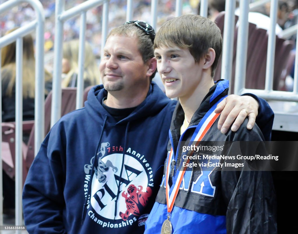 Joe Fick, left, with son Joey, the first father-son wrestlers from Berks County to win PIAA medals, both for Oley Valley.Oley Valley's Joey Fick pins Palmerton's Sam Oberlander in 2:06 to place seventh at 120 pounds.WRESTLING PIAA-AA individual