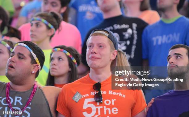 Penn State Berks student Sean Flannery, center, cries during the slideshow of children that died of cancer that year. THON Day 2 Penn State Main-...
