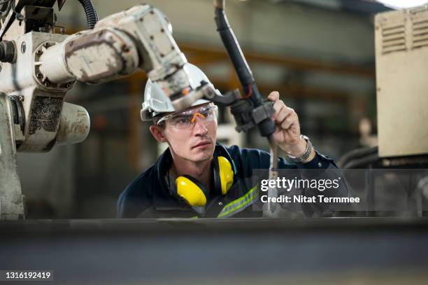 expert engineer working in engineering part production line while adjust the ac balance setting for robotics welding. increase productivity in the work process concepts. - maschinenbau stock-fotos und bilder