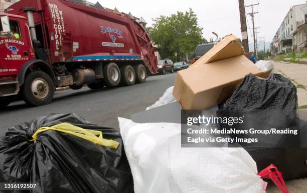 Reading - A J.P. Mascaro & Sons truck drives down the 200 block of N. Oley St. Where piles of trash lined the streets. Some of the bags had flies and...