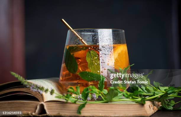 grapefruit and orange juice infused with marijuana with fruit slices - herb stock pictures, royalty-free photos & images