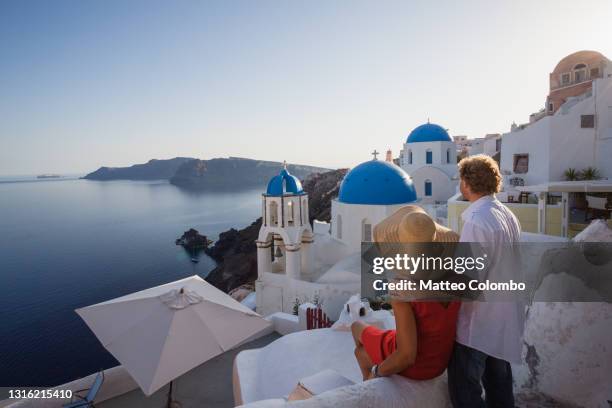 adult couple on vacation in santorini, greece - mediterranean tour stock pictures, royalty-free photos & images