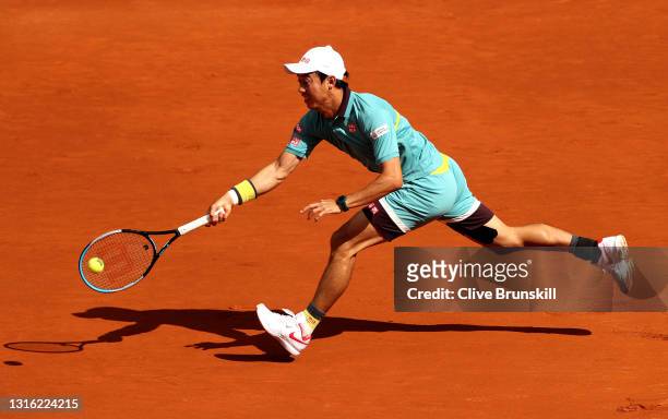 Kei Nishikori of Japan stretches for a forehand in his mens singles first round match against Karen Khachanov of Russia during day six of the Mutua...