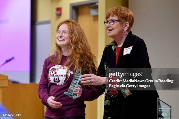 Gov. Mifflin's Hannah Teson accepts the 3rd place trophy from Sylvia Klett World Quest, a trivia-like competition for area high schools, at the...