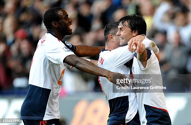 Chris Eagles of Bolton Wanderers celebrates scoring his team's second goal with team mates Fabrice Muamba and Paul Robinson during the Barclays...