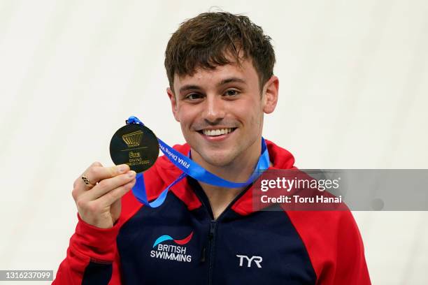 Thomas Daley of Great Britain poses with his gold medal after winning the Men's 10m Platform final on day four of the FINA Diving World Cup at the...