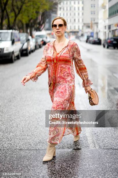 Influencer Alexandra Siedschlag wearing a red boho dress by Ana Alcazar, beige boots by Clou Hamburg, a brown bag by Chloe and sunglasses by Bottega...