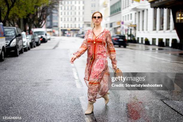 Influencer Alexandra Siedschlag wearing a red boho dress by Ana Alcazar, beige boots by Clou Hamburg, a brown bag by Chloe and sunglasses by Bottega...