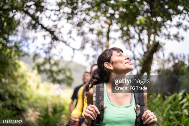 young woman hiking and looking at view - people climbing walking mountain group stock pictures, royalty-free photos & images