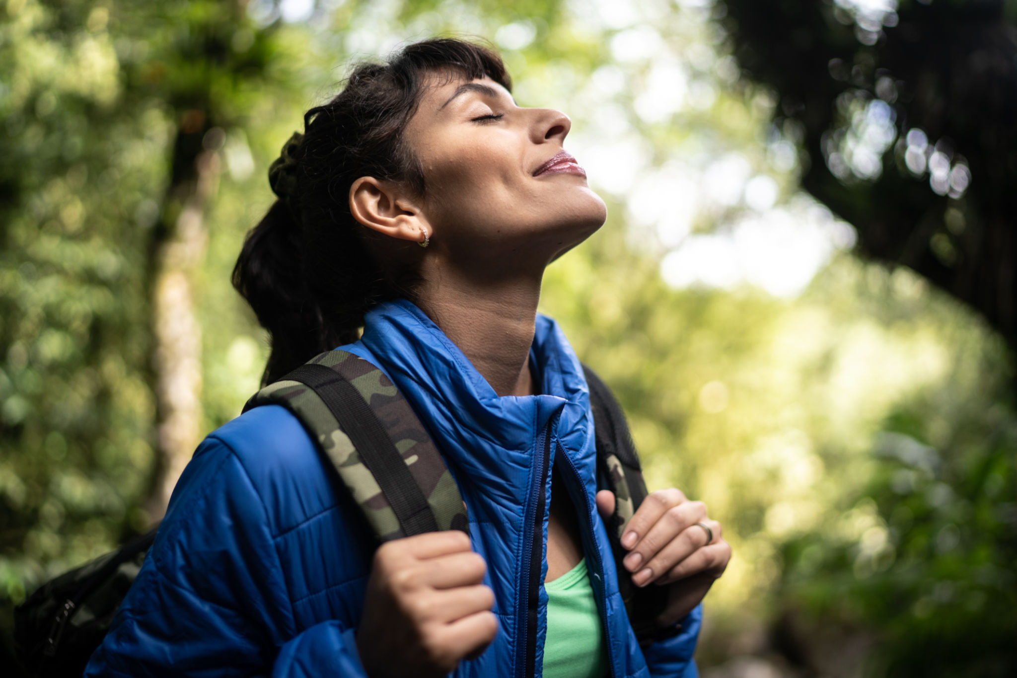 Young woman breathing pure air in a forest Young woman breathing pure air in a forest