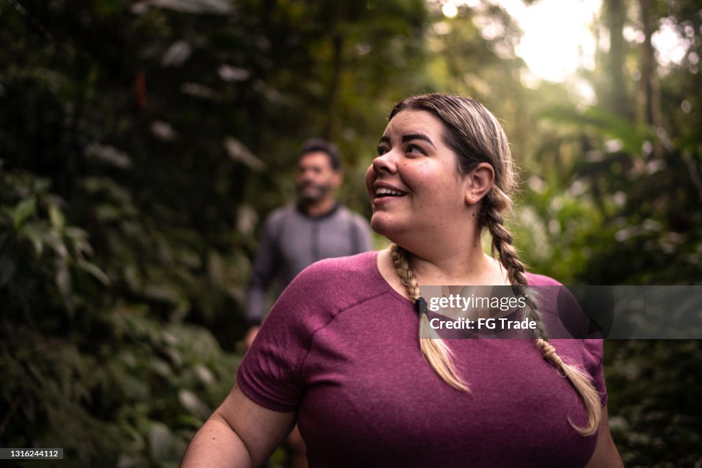 Vrouw die een bos bewondert tijdens het wandelen