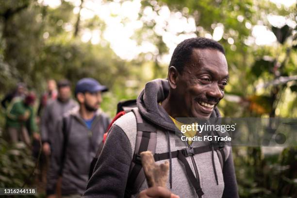 happy senior man hiking with friends - people climbing walking mountain group stock pictures, royalty-free photos & images