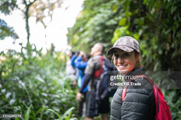 portrait of a woman hiking with friends - in touch with nature stock pictures, royalty-free photos & images