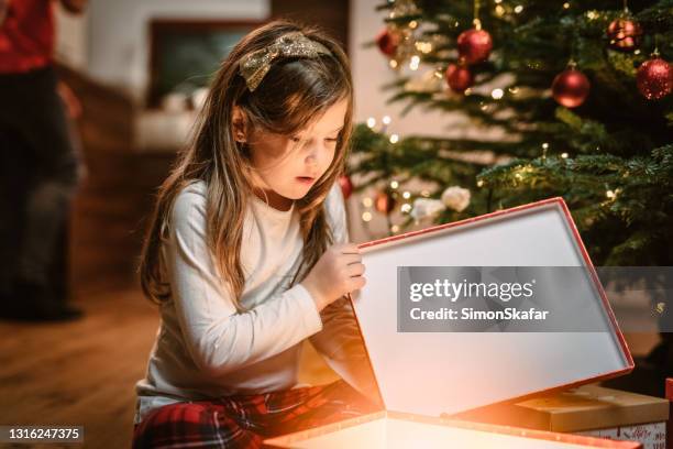 girl surprised on unboxing christmas gift - kids advent stock pictures, royalty-free photos & images