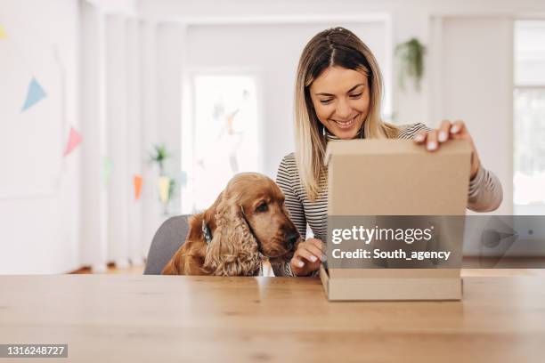 woman opening a package - white box packaging stock pictures, royalty-free photos & images