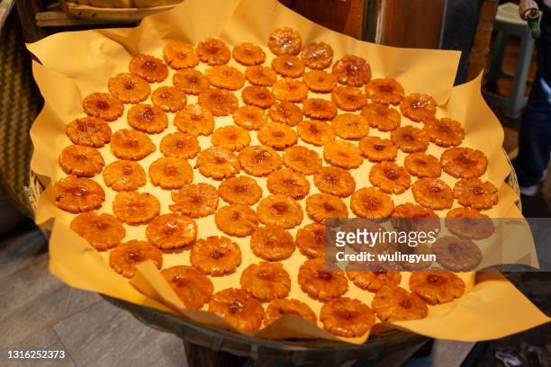 sichuan traditional dried orange cakes in a big bamboo tray - big orange ストックフォトと画像
