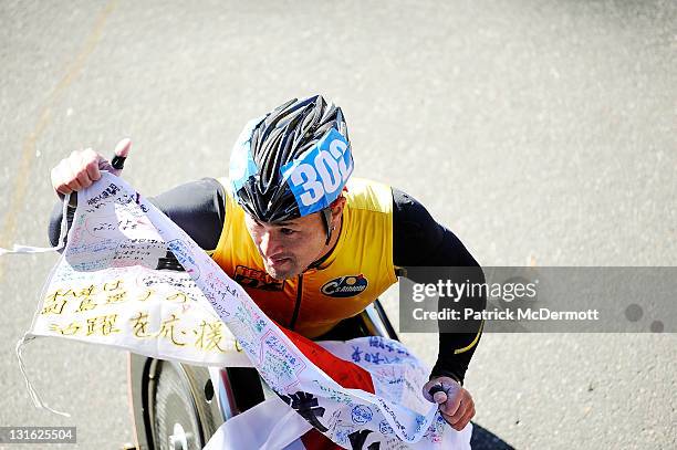 Masazumi Soejima of Japan celebrates after winning the Men's Wheelchair Division in the 42nd ING New York City Marathon in Central Park on November...