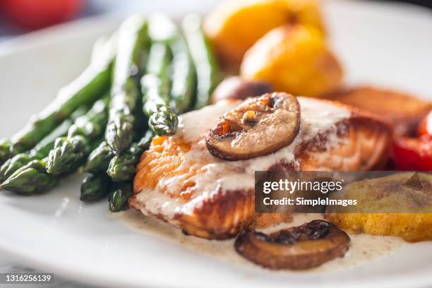 roasted salmon fillet with aparagus, musrooms sauce, tomatoes and baking potatoes. - cooked mushrooms stock pictures, royalty-free photos & images