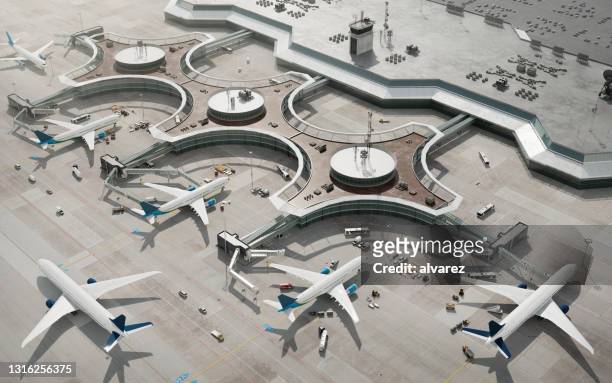 blick aus der vogelperspektive auf das flughafenterminal mit geparkten flugzeugen - flughafen stock-fotos und bilder