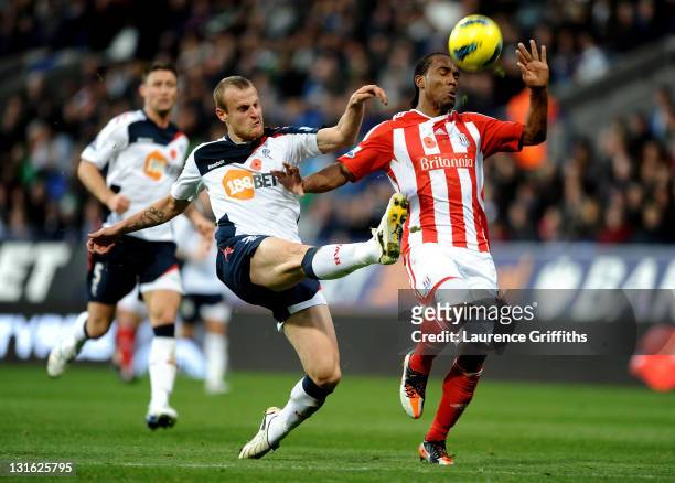 David Wheater of Bolton Wanderers challenges Cameron Jerome of Stoke City during the Barclays Premier League match between Bolton Wanderers and Stoke...