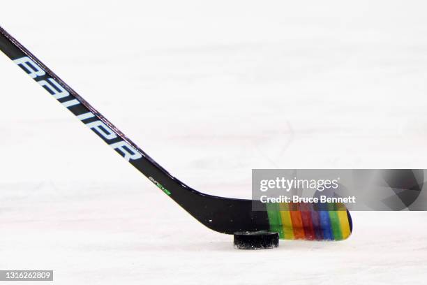 Zac Jones of the New York Rangers skates with a stick decorated for "Pride Night" in warm-ups prior to the game against the Washington Capitals at...