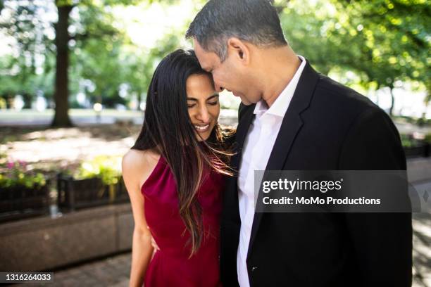 married couple strolling through downtown park - indian couples stock-fotos und bilder