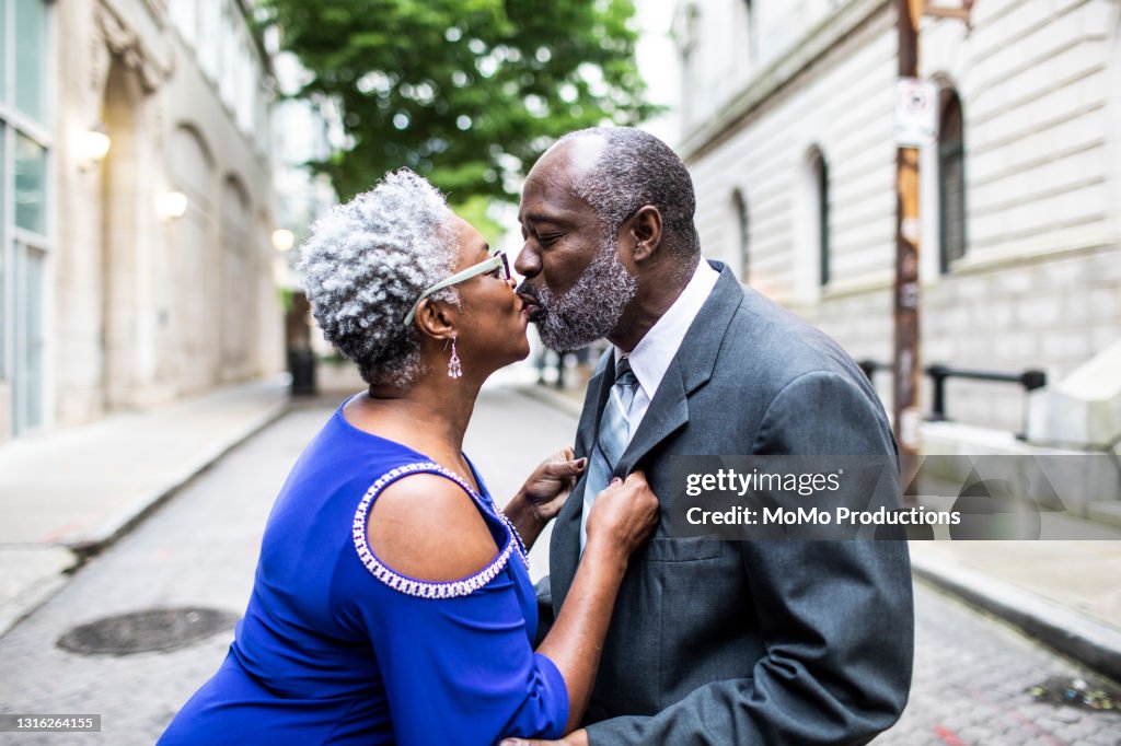 Senior couple kissing in downtown area on a date