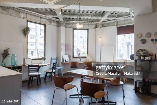 inside of modern cafe with wooden table and chair without people on daytime - サテン ストックフォトと画像