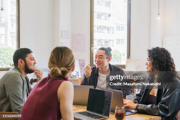 multinational group of generation z entrepreneurs communication on business meeting around the table - business meeting cafe stock pictures, royalty-free photos & images