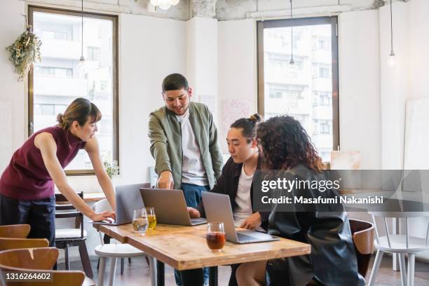 multinational group of generation z entrepreneurs communication on business meeting around the table - asian generation z stock pictures, royalty-free photos & images