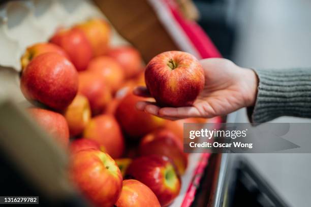 close-up shot of woman shopping fresh organic fruits in supermarket - produce aisle photos et images de collection