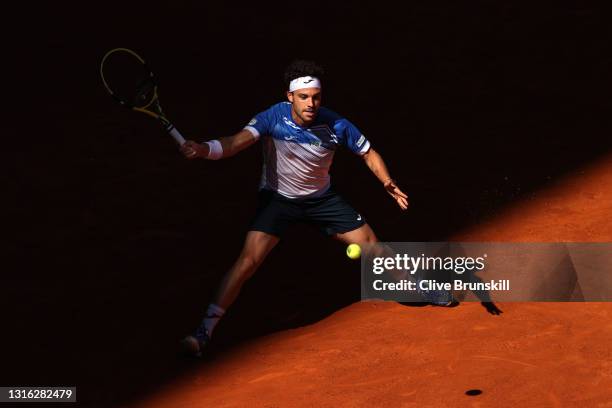 Marco Cecchinato of Italy plays a forehand in his mens singles match against Roberto Bautista Agut of Spain during day six of the Mutua Madrid Open...