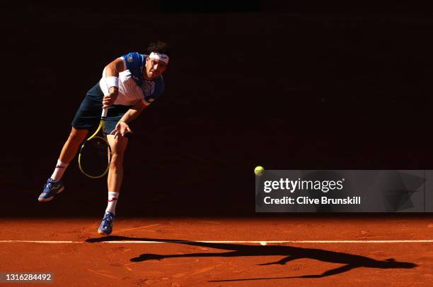 Marco Cecchinato of Italy serves in his mens singles match against Roberto Bautista Agut of Spain during day six of the Mutua Madrid Open at La Caja...