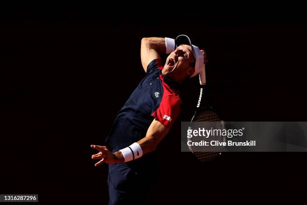 Roberto Bautista Agut of Spain serves in his mens singles match against Marco Cecchinato of Italy during day six of the Mutua Madrid Open at La Caja...