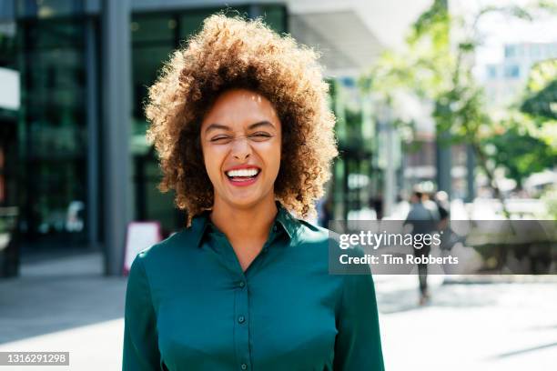portrait of woman laughing - woman black shirt stock pictures, royalty-free photos & images