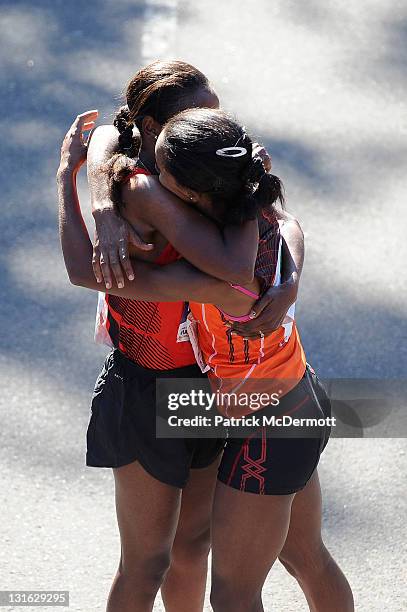 Firehiwot Dado of Ethiopia celebrates with Buzunesh Deba of Ethiopia after winning the Women's Division of the 42nd ING New York City Marathon in...