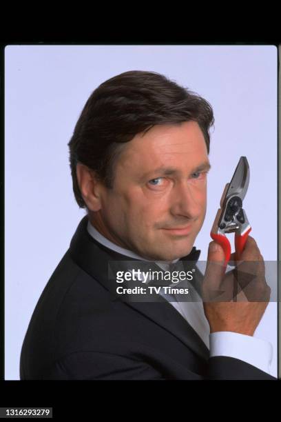 Television presenter and gardening journalist Alan Titchmarsh posed as James Bond, circa 1999.