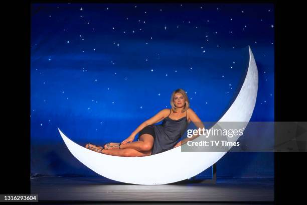 Television presenter Penny Smith laying on a crescent moon, circa 1999.