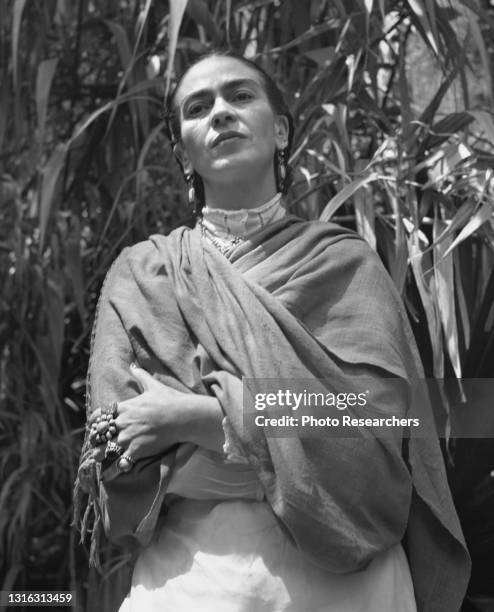 Portrait of Mexican artist Frida Kahlo as she poses in the garden at her home, La Casa Azul, Coyoacan, Mexico City, Mexico, 1952.