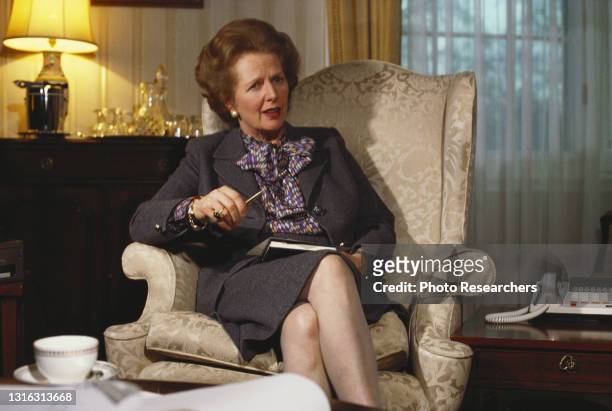 Portrait of British Prime Minister Margaret Thatcher as she sits in an armchair, London, England, circa 1980s.