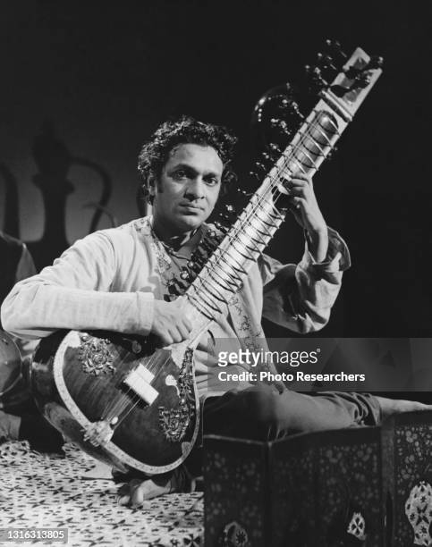 Indian musician and composer Ravi Shankar plays sitar during a performance, 1960s.
