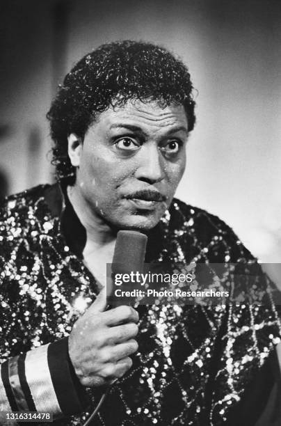 American Rock musician Little Richard holds a microphone during an appearance at an unspecified church, Brunswick, Georgia, 1985.