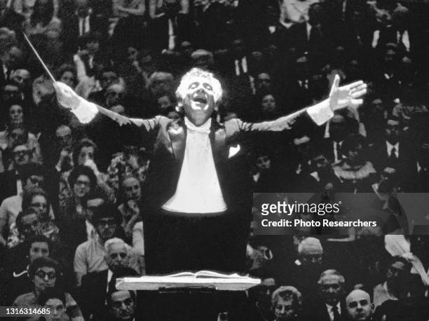 View of American composer and musician pianist Leonard Bernstein as he conducts, 1970s.