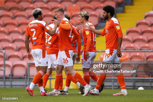 Ellis Simms of Blackpool celebrates with team mates Jordan Lawrence-Gabriel and Daniel Ballard after scoring his team's first goal during the Sky Bet...