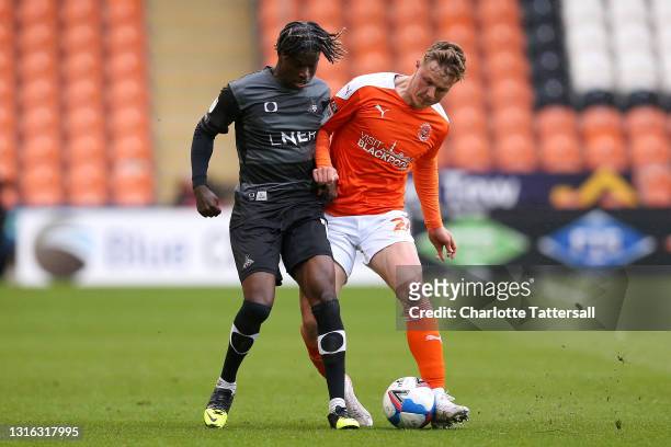 Daniel Ballard of Blackpool is challenged by Taylor Richards of Doncaster Rovers during the Sky Bet League One match between Blackpool and Doncaster...