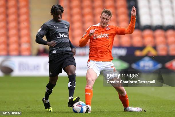 Daniel Ballard of Blackpool is challenged by Taylor Richards of Doncaster Rovers during the Sky Bet League One match between Blackpool and Doncaster...