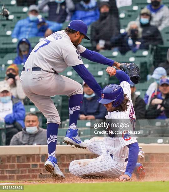 Jake Marisnick of the Chicago Cubs scores on a wild pitch by Dennis Santana of the Los Angeles Dodgers during the third inning of game one of a...