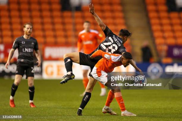 Demetri Mitchell of Blackpool clashes with Branden Horton of Doncaster Rovers during the Sky Bet League One match between Blackpool and Doncaster...